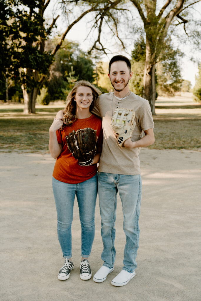 Nebraska Fall Engagement Session at Pioneers Park in Lincoln, Nebraska. Couple holding softball gloves together.