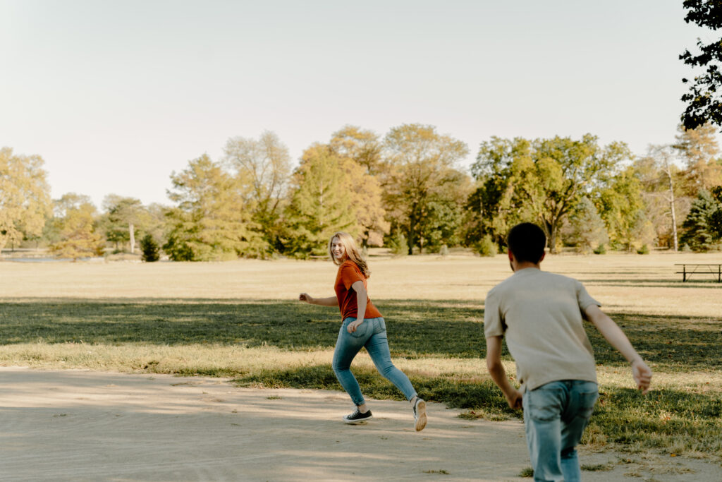 Nebraska Fall Engagement Session at Pioneers Park in Lincoln, Nebraska. Couple playing softball.